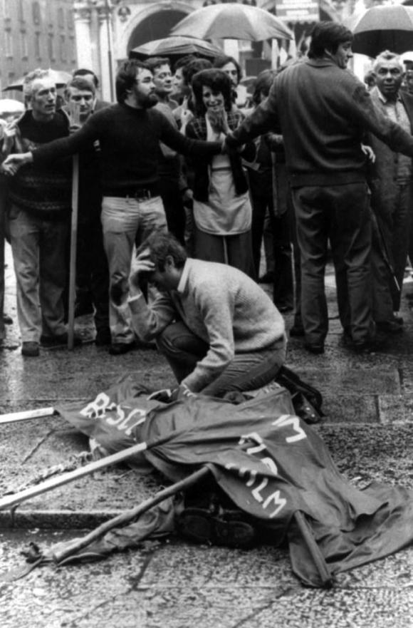 Il corpo di una delle vittime della strage di Piazza della Loggia a Brescia coperto da uno striscione, 28 maggio 1974.
