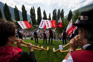 Yodel festival with alphorn musicians and flag throwers
