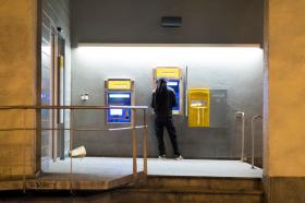 man at postfinace ATM