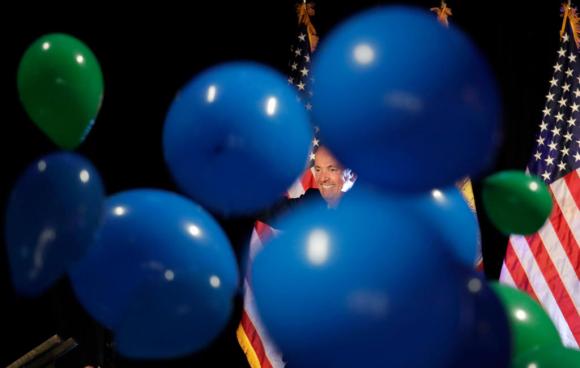 Il neo-governatore del New Jersey Phil Murphy intravisto dietro palloncini di colore blu, al suo party d elezione.