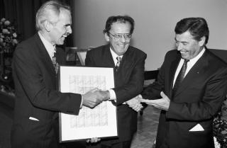 3 men shaking hands and smiling