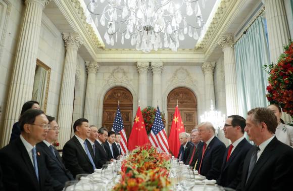 La delegazione cinese e quella americana seduta a un banchetto: in mezzo a destra trump e a sinistra Xi