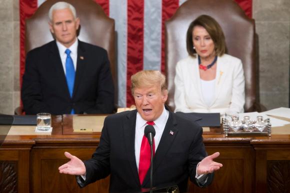 Donald Trump con alle sue spalle il vicepresidente Mike Pence e la speaker della Camera Nancy pelosi