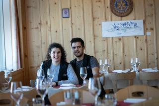 a couple sit in the restaurant of a ski resort