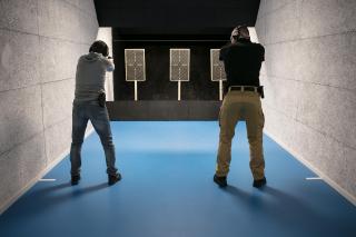 two men aiming