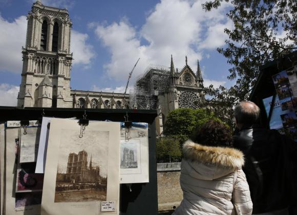 Notre-Dame vista da sud con turisti che la indicano e cavalletto di un pittore di strada che l ha ritratta