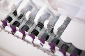Fiale di vaccino antinfluenzale in una confezione multipla di cartone bianco, ritratte da vicino.