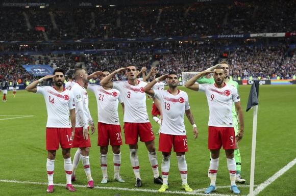 Sette giocatori turchi fanni il saluto militare dopo il pareggio contro la Francia.