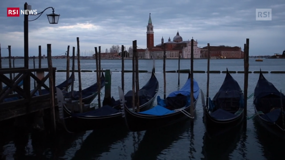Gondole ferme, attraccate su un canale di Venezia che si intuisce essere il canale della Giudecca