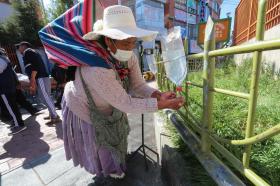 Una donna di etnia Aymara si lava le mani