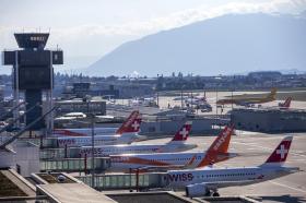 Swiss International Air Lines aircraft and EasyJet aircraft are parked on the tarmac of the Geneve Aeroport.