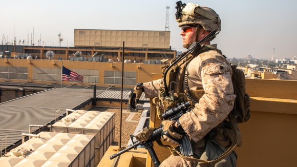 soldato sorveglia dal tetto di un edificio