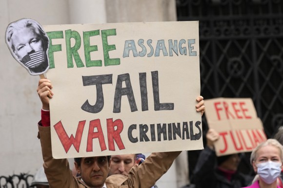 cartello con scritta in inglese liberare assange incarcerare i criminali di guerra