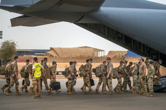 soldati in fila per entrare in un aereo militare