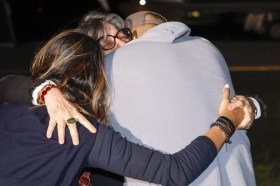 returned US prisoner embraced by relatives
